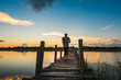 © songdech17 - Man walking on wooden bridge
