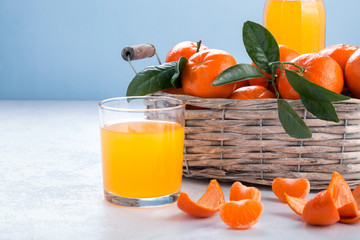 Poster - Full basket of mandarin with a glass of juice