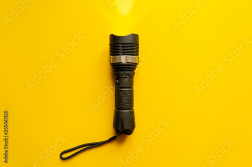 Cuadros en Lienzo steel torch isolated on yellow surface, producing light beams or rays, copy spac