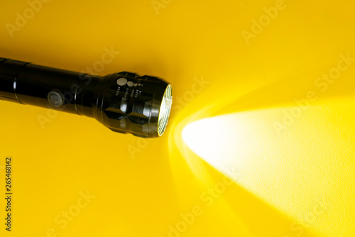 Cuadros en Lienzo steel torch isolated on yellow surface, producing light beams or rays, copy spac