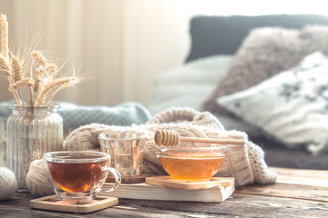 Still life details of home interior on a wooden table with a Cup of tea