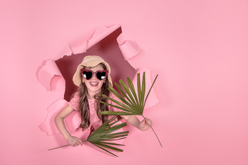 Poster - funny little girl in hat and glasses on colored background