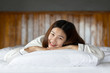 © 220 Selfmade studio - Beautiful Attractive Asian woman wearing Pajamas sleep smile sleep and sweet dream on bed in bedroom in the morning feeling so relax and comfortable,Healthcare and Sleep Concept