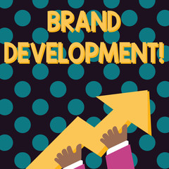 Word writing text Brand Development. Business photo showcasing improving customers knowledge and opinions of a brand photo of Hand Holding Colorful Huge 3D Arrow Pointing and Going Up