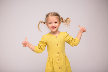 Wall Mural - girl blonde green linen dress white background.girl the blonde smiles.the concept of summer and natural fabrics. space for text