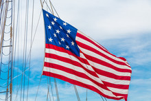 An American Flag Flying From The Riggings Of A Tall Ship