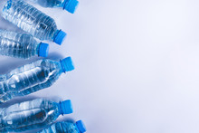 Several Drinking Water Bottles On White Background. Eco Concept. Copy Space For Your Text.