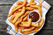 © myviewpoint - close-up of churros on plate with chocolate sauce
