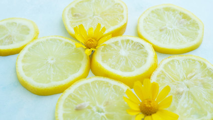 Wall Mural - Yellow organic lemon slices shows fresh citrus fruit close up, light and airy fruit.