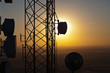 © Mint Images - Silhouette of communications tower against sunset sky