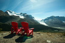 Red Lawn Chairs Overlooking Scenic Mountain Landscape
