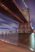 Brooklyn Bridge From East River Beach At Night With Manhattan Bridge On The Background