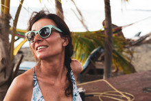 Portrait Of A Woman On The Beach Wearing Sunglasses