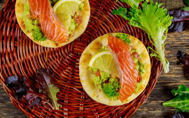 Wall Mural - Toasts with avocado , smoked salmon and green salad