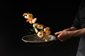 Wall Mural - Sea food, cooking shrimp with herbs, on a dark background, horizontal photo, healthy and wholesome food
