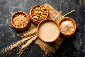 Wall Mural - Sattu sharbat is a cooling sweet drink made in summer with roasted black chickpea flour, barley, suger, salt & water. served in a glass. selective focus