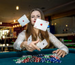 © RomanR - Upset woman in casino with falling cards