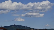 Turin, Piedmont, Italy. April 2019. On A Beautiful Spring Day, Intense Sun With Blue Sky And Strong Clouds Passing Over The Basilica Of Superga. Time Lapse 25fps