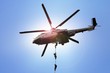 Military commando helicopter drops under bright daylight