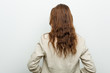 © Asier - Young european business woman from behind, looking back.