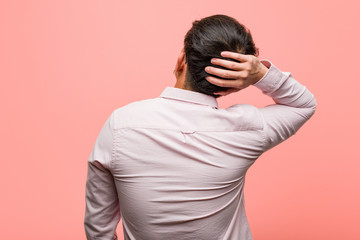 Young chinese man from behind thinking about something