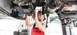 © industrieblick - Automechaniker in Werkstatt repariert Fahrzeug // car mechanic in work clothes works in a workshop and repairs a vehicle