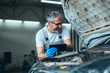 © cherryandbees - worker holding tablet in car service