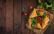 Asian food. Samsa (samosas) with chicken fillet and cheese on wooden background. Top view