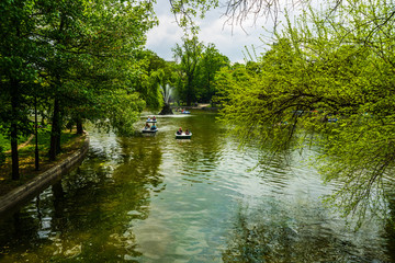 Wall Mural - Bucharest, Romania - 2019. Tourists on the lake of Cismigiu Gardens taking a boat ride.