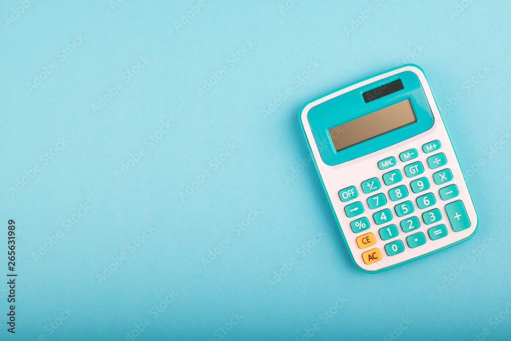 close-up and selective focus shot, calculator on blue background. copy space for text - obrazy, fototapety, plakaty 