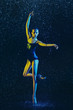 © master1305 - Young female ballet dancer performing under water drops and spray. Caucasian model dancing in neon lights. Attractive woman. Ballet and contemporary choreography concept. Creative art photo.
