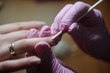 © bo.kvk - Manicurist makes a hygienic manicure with the help of an orange stick close-up