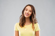 © Syda Productions - people concept - smiling young woman or teenage girl in blank yellow t-shirt over grey background