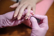 © bo.kvk - Manicurist applies varnish on the nail close up
