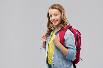 Poster - education, school and people concept - happy smiling teenage student girl with bag over grey background