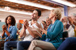 © Monkey Business - Group Attending Neighborhood Meeting In Community Center Clapping