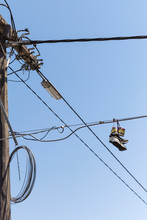 Sneakers Hanging From Telephone Line Exchange.