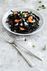 Wall Mural - Squid ink pasta with prawns and tomatoes