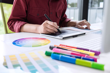 Poster - Image of female creative graphic designer working on color selection and drawing on graphics tablet at workplace
