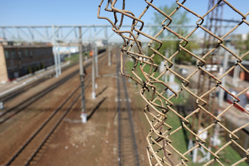 Steel mesh-grid and the railway behind it.