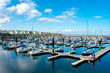 Yachts  and motorboats docked at marina in Bangor. Sailboat Harbor against blue sky