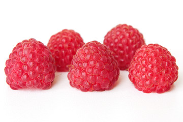 Wall Mural - fresh juicy red raspberries on white background