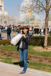 © belart84 - Close up portrait of a smiling excited girl holding cotton candy in the park close to fountain.