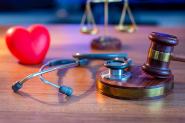 Justice Gavel and stethoscope with red heart on background.law concept Judge law medical Pharmacy compliance Health care business rules. 