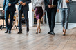 cropped view of multicultural businessmen and businesswomen walking in office