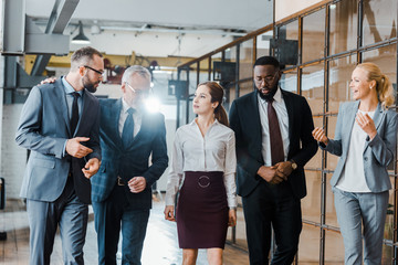 multicultural group of businessmen and businesswomen standing in office