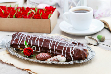 Canvas Print - Eclair with chocolate and cup of coffee.