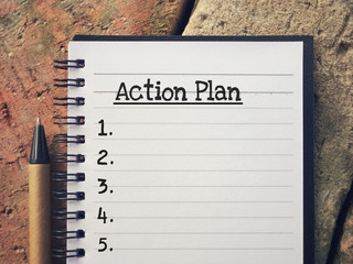 New Year Plan concept - Action Plan written on a notepad.