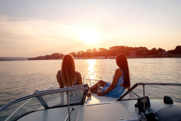 Wall Mural - Girls are having drink on a boat