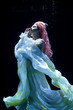 © Embrace of Beauty - woman with pink hair in white dress underwater. Mermaid, nymph or drowning in white dress under water